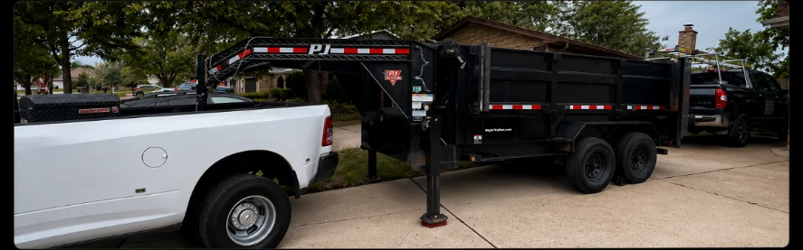 Thatsjunk white truck hitched to a black PJ dump trailer in a Lake County driveway